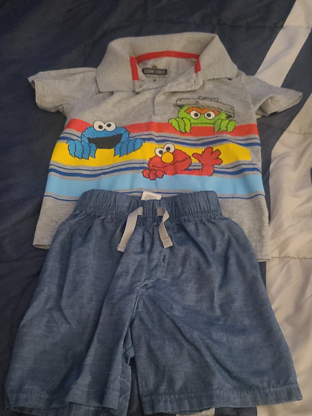 Sesame Street Gray Polo with Multicolor Character Stripes and Blue Shorts